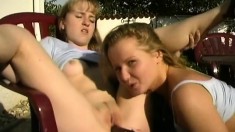 Two adorable blonde teens having lots of fun with sex toys outside